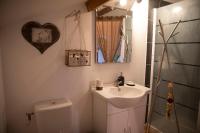 a bathroom with a sink and a toilet and a mirror at Le Chat Blanc in Versols-et-Lapeyre
