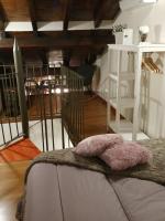 A bed or beds in a room at La Buhardilla de Andrea
