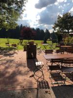a group of picnic tables and benches in a park at Solhof-Schömberg in Loßburg