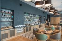 a restaurant with tables and chairs and a bar at Expo Hotel Sofia - Free Airport Shuttle in Sofia