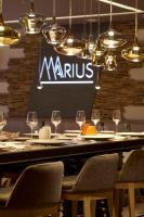 a table with chairs and wine glasses in a restaurant at Hotel Le Tremplin in Méribel