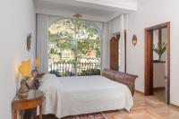 a bedroom with a bed and a large window at Hotel Poseidon in Positano