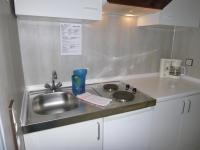 a kitchen with a sink and a counter top at Haus Delphin in Bad Wildungen