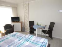 a bedroom with a bed and a table and chairs at Haus Delphin in Bad Wildungen