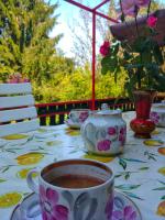 a cup of coffee on a table with flowers on it at Kuća za odmor &quot;Livadica&quot; in Netretić