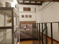 A bed or beds in a room at La Buhardilla de Andrea