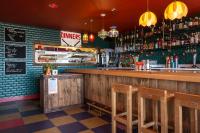 Graduate by Hilton Madison في ماديسون: بار مع كراسي خشبية ومنضدة