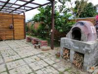 a patio with an outdoor oven with two benches at Celine&#39;s B&amp;B in Fenglin