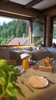 a table with food on it in a room with a window at Haus Sieben - Singer Lydia in Kötschach
