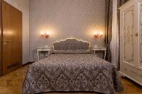 a bedroom with a large bed with two tables at Hotel Mezzo Pozzo in Venice