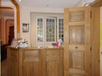 a kitchen with wooden cabinets and a window at Hotel Manitoba in Blankenberge