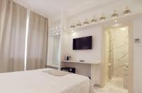 Łóżko lub łóżka w pokoju w obiekcie FLOS Guest House