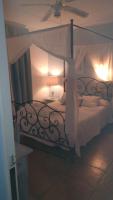 a bedroom with a large bed with a canopy at Macavi in Rota