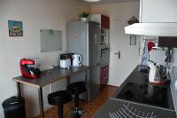a kitchen with a counter and a refrigerator at Appartement Le Grand Parc in Châteauroux