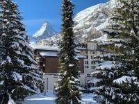 a resort in the mountains with snow covered trees at Villa Emeline in Zermatt