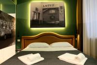 a bedroom with a bed with two towels on it at OFFICINA TESINI Guest Rooms Verona in Verona