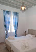 Postel nebo postele na pokoji v ubytování Gryparis' Club Apartments
