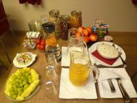 a table with a bunch of fruit and glasses of juice at Cafe und Pension Blohm in Greifswald