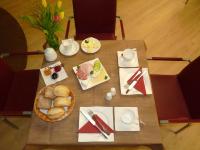 a table with a bowl of food and a basket of bread at Cafe und Pension Blohm in Greifswald