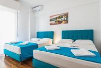 Postel nebo postele na pokoji v ubytování Super Paradise Apartments