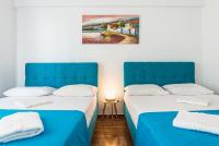 Postel nebo postele na pokoji v ubytování Super Paradise Apartments