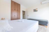 Postel nebo postele na pokoji v ubytování Super Paradise Apartments
