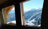 a window with a view of a snow covered mountain at Hotelski in Verbier