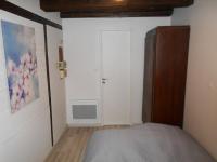 a bedroom with a bed and a closet and a door at La cour des meuniers - le Froment et l&#39;Epeautre in Kaysersberg