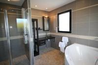 a bathroom with a shower and a sink and a tub at Contemporary Villa of Kerseal in Gouesnach