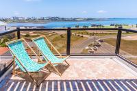 two chairs on a balcony with a view of the ocean at Malibu OceanView Homestay in Magong