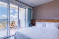 Un pat sau paturi &icirc;ntr-o camer&#x103; la Malibu OceanView Homestay