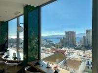 a room with a large window with a view of the city at The Eliott Hotel in Gibraltar