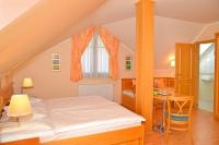 A bed or beds in a room at Vadászkürt Panzió