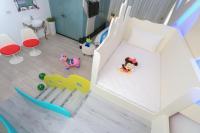 a childs bedroom with a white bed and toys at Chi Heng Homestay in Luodong