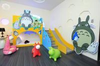 a childs room with a dinosaur wall mural and toys at Chi Heng Homestay in Luodong