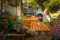 a wooden table and bench in a garden with flowers at Urbangut in Sankt Michael im Lungau