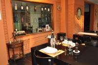 a dining room with a table with wine glasses at Hotel de Campo Posada la Esperanza in Río Cuarto