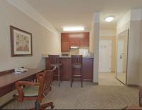 a kitchen with a table and chairs in a room at Holiday Inn Express Hotel & Suites San Dimas by IHG in San Dimas