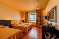 A bed or beds in a room at Victoria Terme Hotel