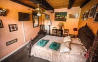 a bedroom with a bed and a ceiling fan at la maison d&#39;idylle in Combourg