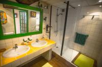 a bathroom with two sinks and a shower at la maison d&#39;idylle in Combourg