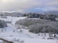 a village covered in snow with trees and houses at Gîte la Sapinière in Labaroche