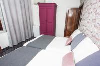 a bedroom with a bed with a red cabinet at Hostal Caminito del Rey in Alora