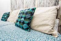 a bed with two pillows on top of it at Hostal Caminito del Rey in Alora
