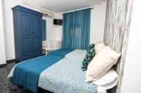 a bedroom with a bed with a blue cabinet at Hostal Caminito del Rey in Alora