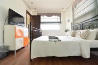 a bedroom with a large bed and a flat screen tv at Penghu Chenhi Bay Homestay in Baisha