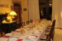 a long table with plates and wine glasses on it at Chambres d&#39;hôtes les Etoiles in Mareugheol