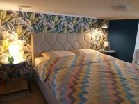 A bed or beds in a room at Tempo Life Apartman