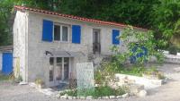 a small stone house with blue shutters on it at Taillefer in Saint Paul de Loubressac