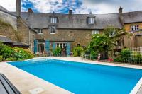 a swimming pool in front of a house at la maison d&#39;idylle in Combourg
